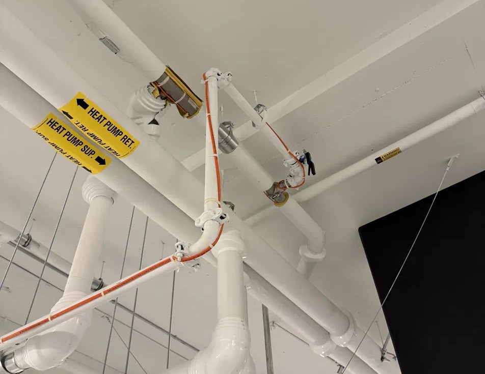 Self-regulating heat trace on insulated heat pump supply and return piping